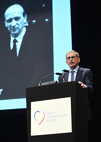 Dr John Mandrola delivers the Paul Wood Lecture (with Dr Wood pictured on screen)